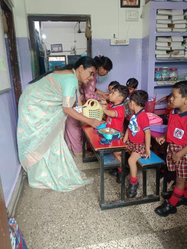 Teacher guiding little learners